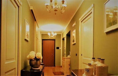 a hallway with a vase of flowers on a table at Glamour Bed & Breakfast in Montalto Uffugo
