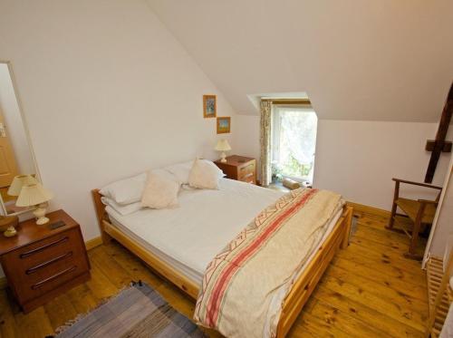 a bedroom with a large bed and a window at lesChenes in Saint-Dolay