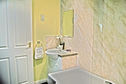 a bathroom with a sink and a mirror at Bridge of Cally Hotel in Blairgowrie