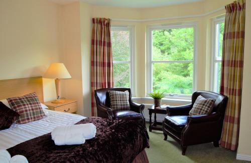 A bed or beds in a room at Bridge of Cally Hotel