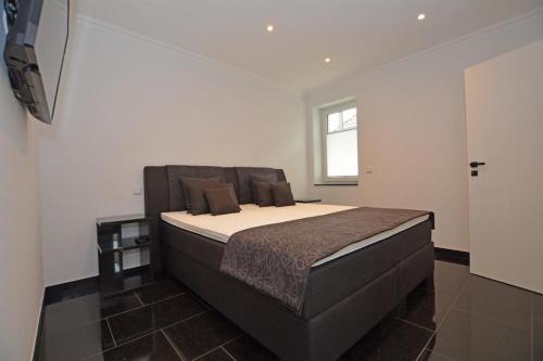 ein Schlafzimmer mit einem großen Bett in einem Zimmer in der Unterkunft Ferienhaus Merzijana in Büsum