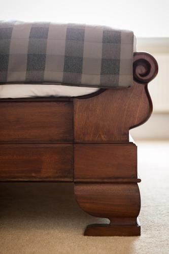 a close up of a bed with a plaid mattress at Goldsborough Hall in Knaresborough