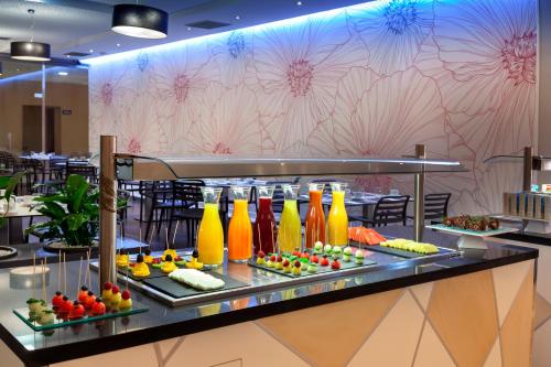 a buffet line with fruits and vegetables on display at Barceló Punta Umbría Beach Resort in Punta Umbría