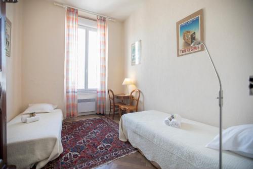 une chambre d'hôtel avec deux lits et une fenêtre dans l'établissement Bohemian Apartment by Connexion, à Cannes