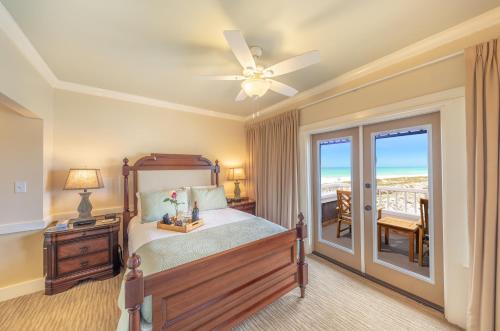 a bedroom with a bed and a ceiling fan at Henderson Park Inn in Destin