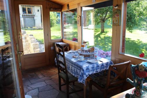 a table with a blue and white table cloth on a porch at Chalet Le Slalom in Arveyes