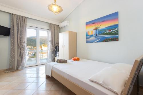 a bedroom with a bed and a large window at Villa Skala Marion (Michalis) in Skala Marion
