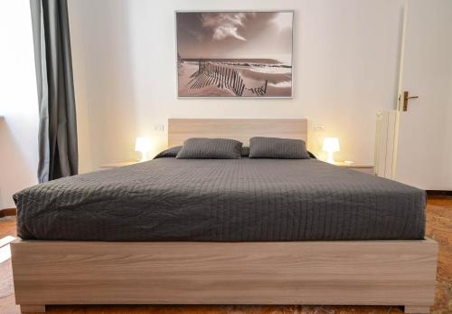 a bedroom with a large bed with two pillows at Bellagio Apartment in Bellagio