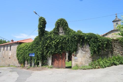 an old building with ivy growing on top of it at Pazo de Chaioso Ribeira Sacra in Maceda
