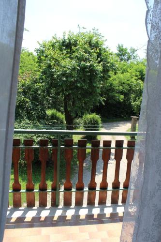 a balcony with a fence with a tree in the background at Il Casolare del Medio Olona in Fagnano Olona