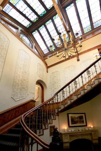 a spiral staircase with a skylight and a ceiling at Macdonald Kilhey Court Hotel in Wigan