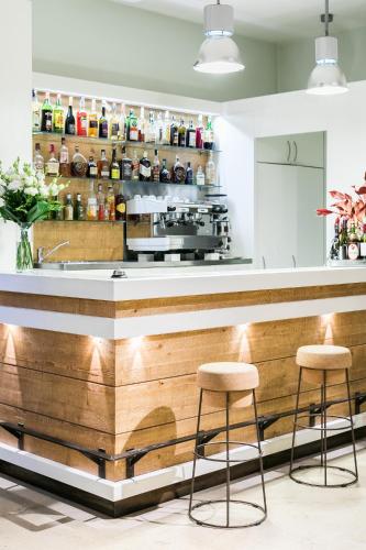 a bar with two stools in front of a counter at Hotel La Rovere in Rome