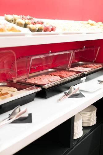 a buffet line with many different types of food at Hotel La Rovere in Rome
