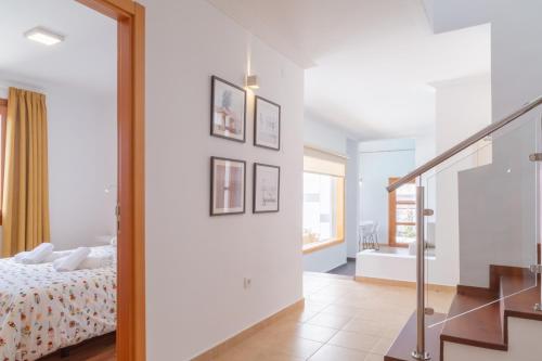 a white bedroom with a bed and a bathroom at Playa Blanca Beach Mate in Playa Blanca