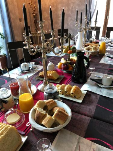 a table topped with bread and orange juice and orange juicefficientfficientfficient at A l'Aube des Volcans in Charbonnières-les-Vieilles