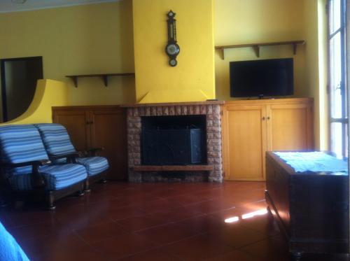 a living room with a fireplace and a tv at la casa per le tue vacanze in Milazzo