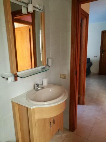 a bathroom with a sink and a mirror at Arinaga Beach & Pool Apartment in Arinaga