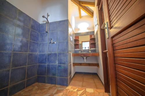 a bathroom with a shower and a sink at Sunset Surf Camp in Saint-François