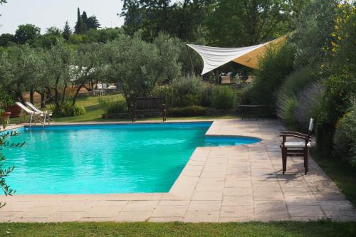 a swimming pool with blue water in a yard at I Parigi Corbinelli Residenze in Florence