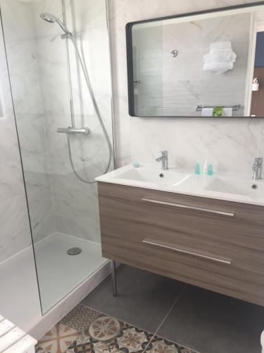 a bathroom with a sink and a shower at Le Galion Hotel et Restaurant Canet Plage - Logis in Canet-en-Roussillon