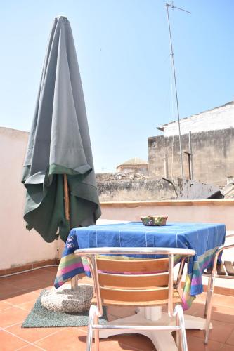 a patio table with a umbrella and two chairs at B&b Lemon Garden in Sciacca