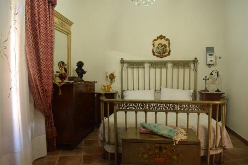a bedroom with a bed and a dresser and a mirror at B&b Lemon Garden in Sciacca