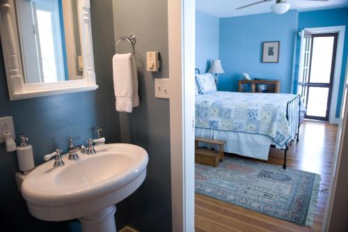 a bathroom with a sink and a bedroom with a bed at Hopkins Ordinary Bed, Breakfast and Ale Works in Sperryville