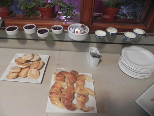 two plates and two trays of croissants and other pastries at Mirando al Sur in San Carlos de Bariloche
