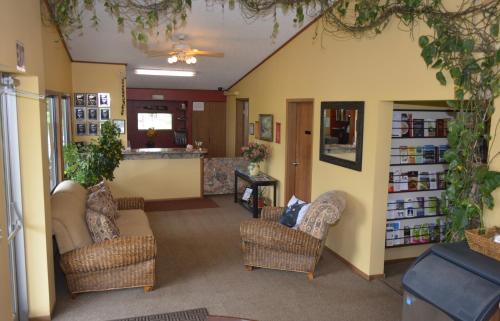 a living room with two chairs and a couch at Arbor Inn of Historic Marshall in Marshall