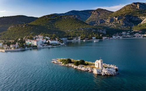 an island with a church in the middle of a body of water at Apartments Tamaris in Klek