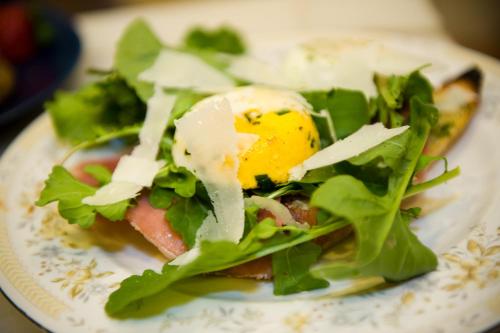 a plate of food with an egg and lettuce at Hopkins Ordinary Bed, Breakfast and Ale Works in Sperryville