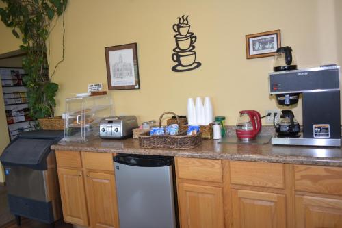 a kitchen with a counter top with a coffee maker at Arbor Inn of Historic Marshall in Marshall