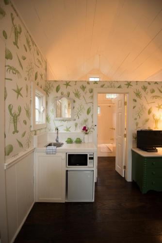 a kitchen with a sink and a stove top oven at The Cottages at Cabot Cove in Kennebunkport