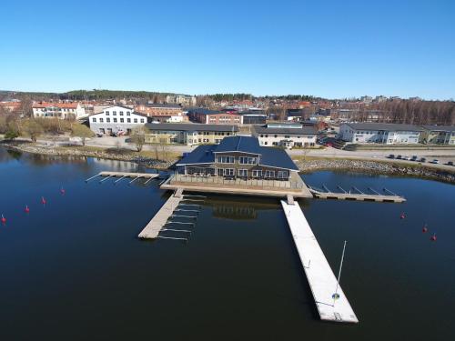 a house on a dock in the middle of the water at Strandpiren Hotell in Hudiksvall