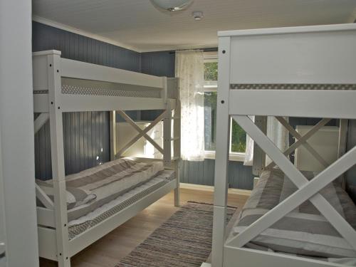 two bunk beds in a room with blue walls at Kårstua - Austrått Agroturisme in Austrått
