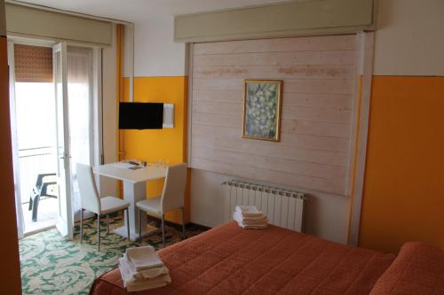 Voodi või voodid majutusasutuse Hotel Poggio d'Oro toas