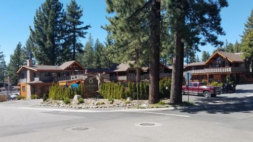 a lodge with a red truck parked in front of it at Gondola Lodge & Tahoe Beach Club in South Lake Tahoe