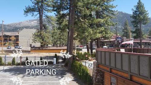 a parking lot in a town with a fence and trees at Gondola Lodge & Tahoe Beach Club in South Lake Tahoe