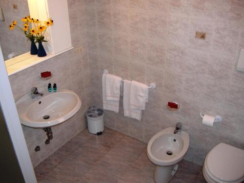 a bathroom with a sink and a toilet at Casa Giuly in Villa dʼAlmè