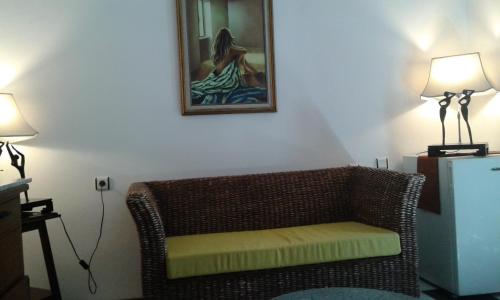 a wicker chair sitting in a room with two lamps at ece "vegan"hotel Bodrum in Golturkbuku