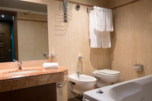 a bathroom with a sink and a toilet and a mirror at Hotel Arcobaleno in Taureana