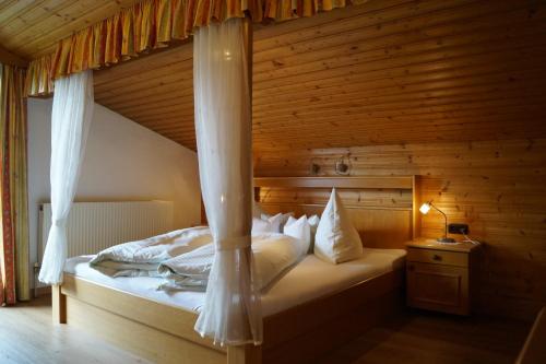 a bedroom with a bed with a canopy at Schusterhof in Innsbruck