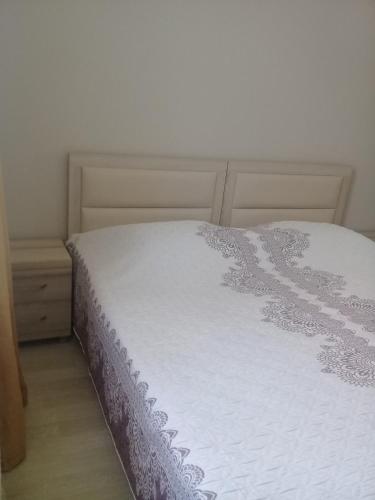 a bedroom with a bed with a white bedspread at Vacation Home Nukri in Gonio