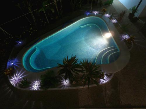 an overhead view of a swimming pool at night at Las Perlitas Rentals Playa Samara in Sámara