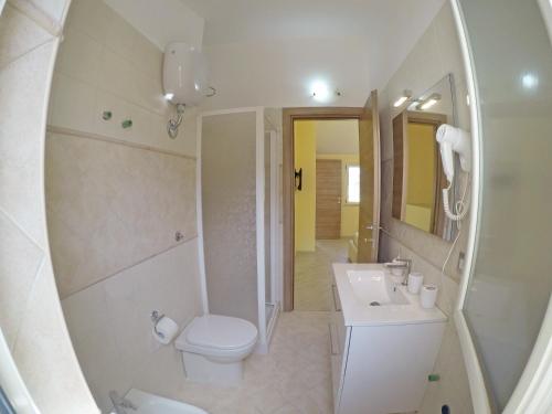 a white bathroom with a toilet and a sink at BB Aretè in Scilla