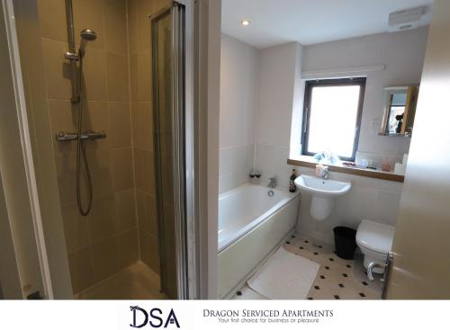 a bathroom with a tub and a toilet and a sink at Birmingham City Centre Premier Apartment in Birmingham