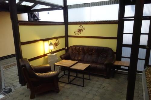 a waiting room with a leather couch and a table at Apartmány Modus 2 in Česká Ves