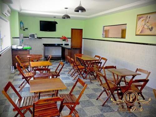 a dining room with wooden tables and chairs at Rio Preto Hotel in Formosa