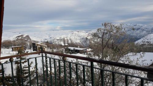 a balcony with a view of a snow covered mountain at Great Chalet Farellones in Farellones