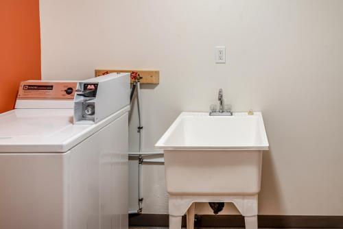 a kitchen with a sink and a microwave at Motel 6-Fort Nelson, BC in Fort Nelson